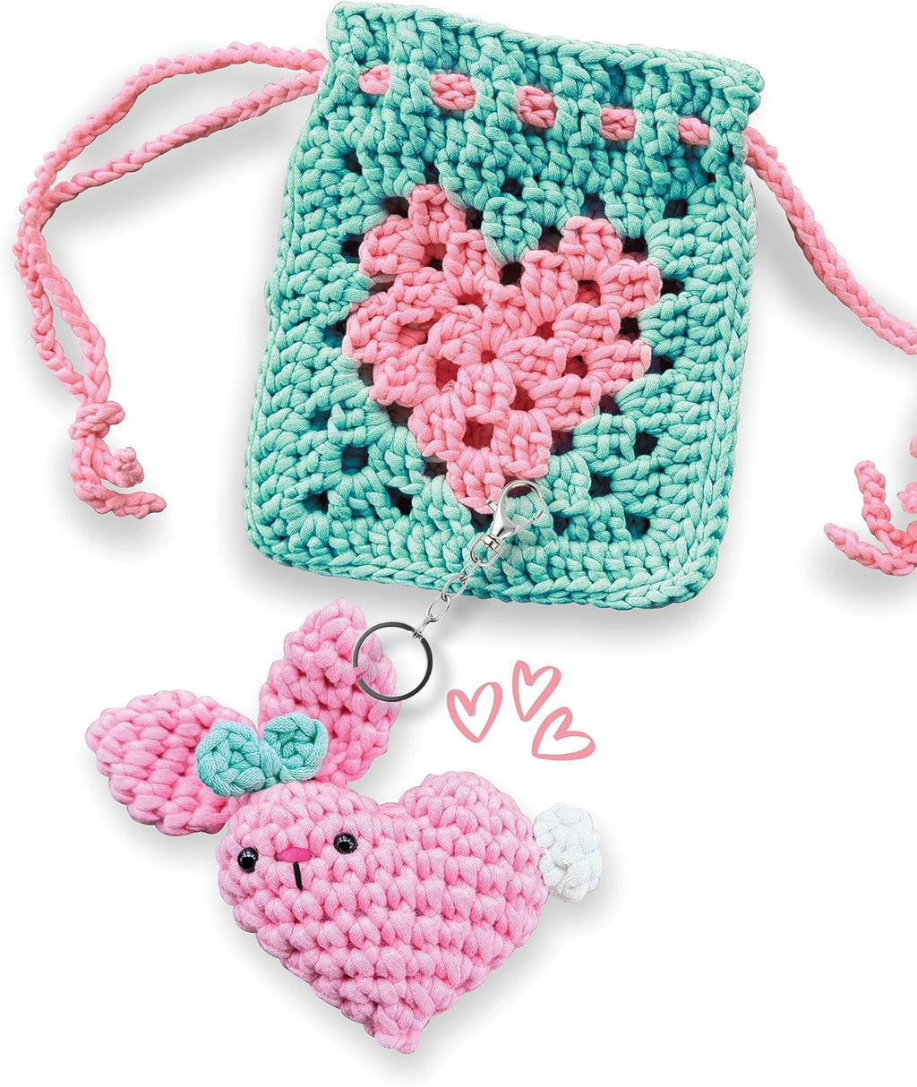 Crocheted heart-shaped pouch with pink heart keychain on a white background